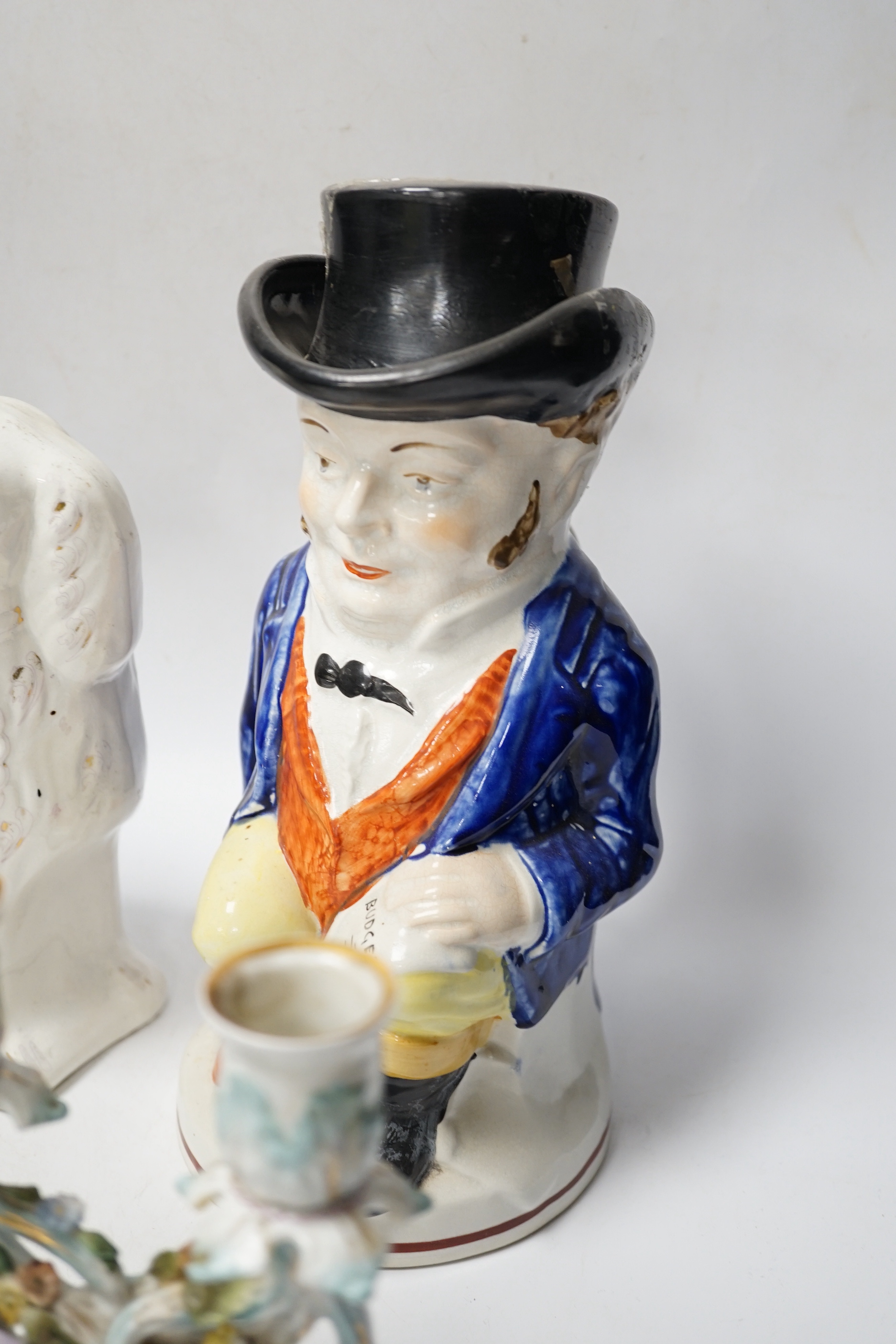 A pair of 19th century French figural two branch candelabra, 17cm high, together with two Staffordshire character jugs and a pair of Kings Charles Spaniel figures